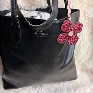 kate spade black leather tote with pink glitter flower charm
